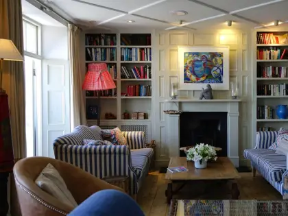 Living room with fitted bookshelves and armchairs
