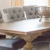 Oak trestle table with tufted upholstered chairs